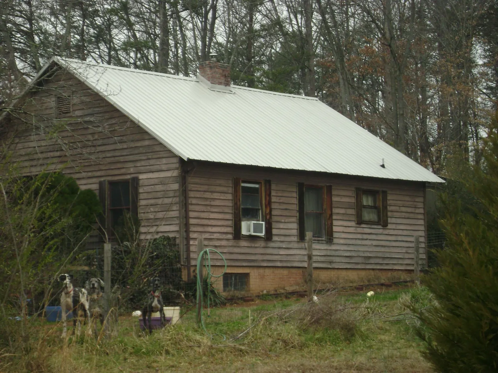 White metal roof on an old wood sided farmhouse, from a Metal Roof Installation job in Zanesville